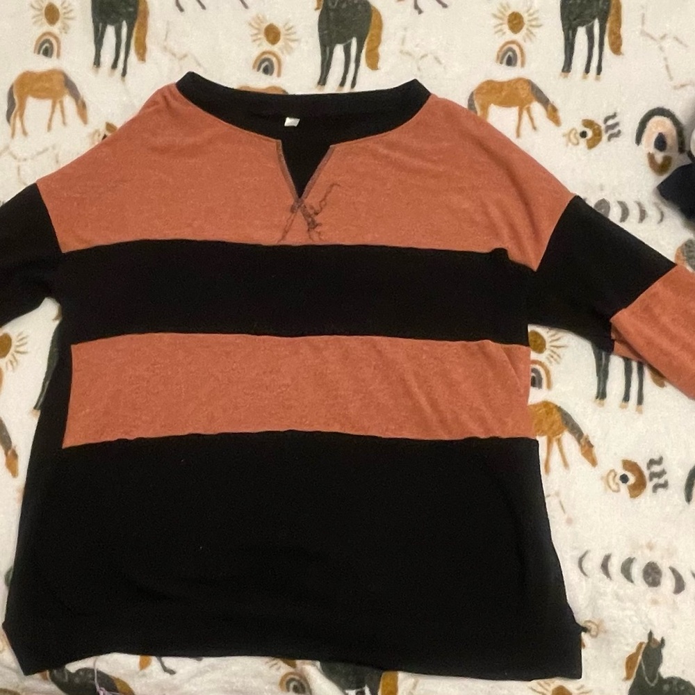 A soft brownish, orange and black sweater, very comfy and casual